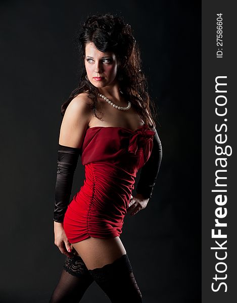 Portrait of expressive brunette posing in dress in the studio on black background. Portrait of expressive brunette posing in dress in the studio on black background