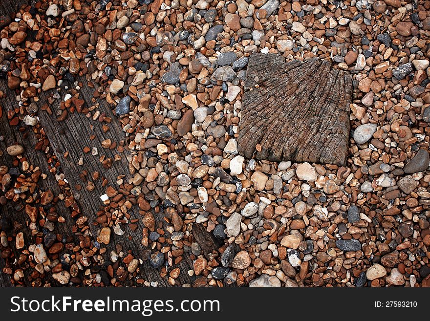 Wooden tiles on a pebble beach