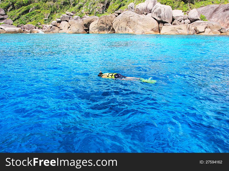 Young man snorkeling in clean water over coral reef, in Similan Island Phangnga South of Thailand. Young man snorkeling in clean water over coral reef, in Similan Island Phangnga South of Thailand