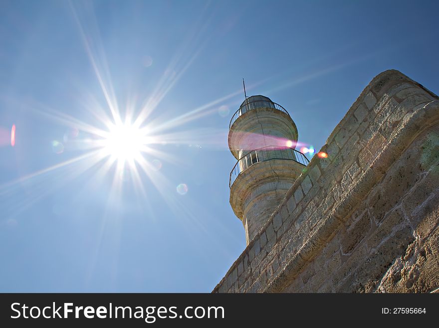 The sunrays and the old lighthouse in Chania, Crete. The sunrays and the old lighthouse in Chania, Crete