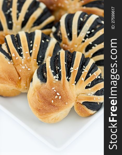 Sweet bread with black sesame cream and sprinkle with sesame put on a dish