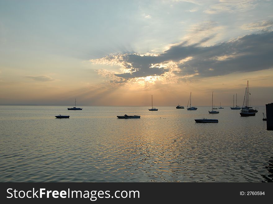 Yachts sitting in sea at sunrise. Yachts sitting in sea at sunrise