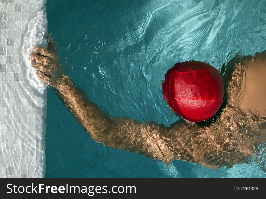 Swimming man touch the board of a pool. the photo has a conceptual meaning: reaching a scope,. Swimming man touch the board of a pool. the photo has a conceptual meaning: reaching a scope,