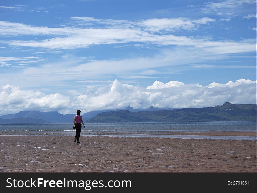 Female on remote sandy beach in Wester Ross, NW Scoctland