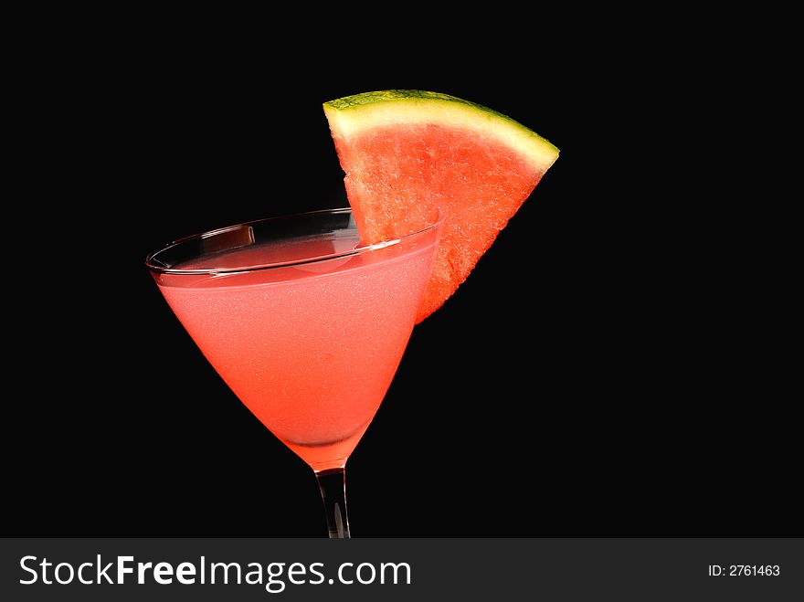 A watermelon martini with a watermelon slice tilted to left