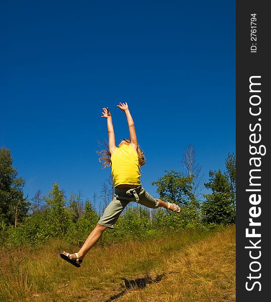 Picture of a Girl jumping on a meadow