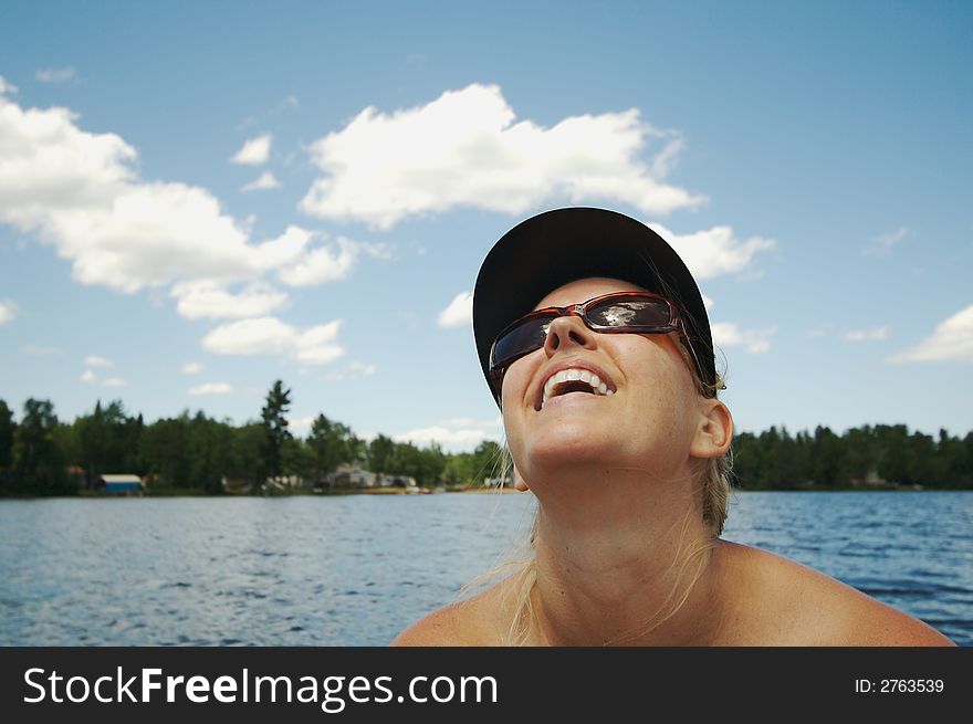 Happy Woman on Lake during a warm summer day.