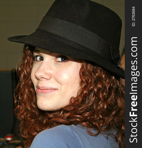 Cute teenage with black hat on and looking over her shoulder. Cute teenage with black hat on and looking over her shoulder