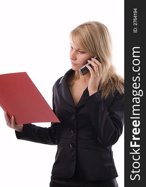 The businesswoman reads documents and speaks by phone. The businesswoman reads documents and speaks by phone.