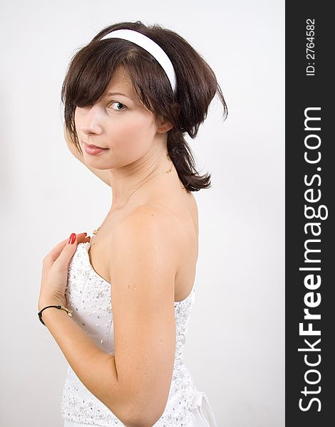 Beautiful white woman in a wedding dress isolated on a white background posing. Beautiful white woman in a wedding dress isolated on a white background posing