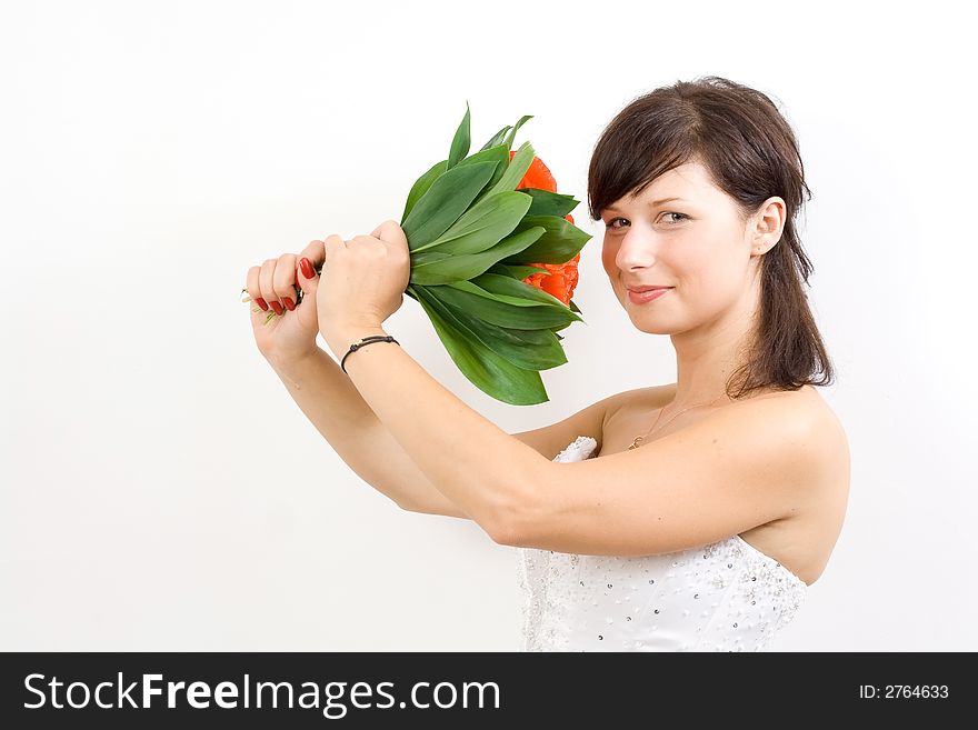 Beautiful white woman in a wedding dress isolated on a white background with flowers smiling. Beautiful white woman in a wedding dress isolated on a white background with flowers smiling