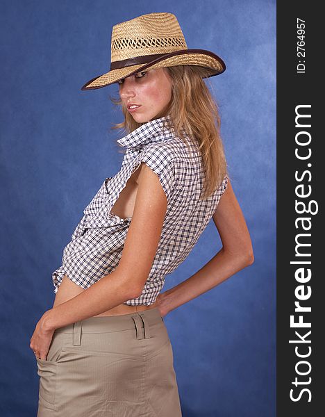 Woman and a cowgirl hat on a blue background