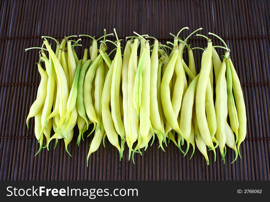 String yellow beans on a white background