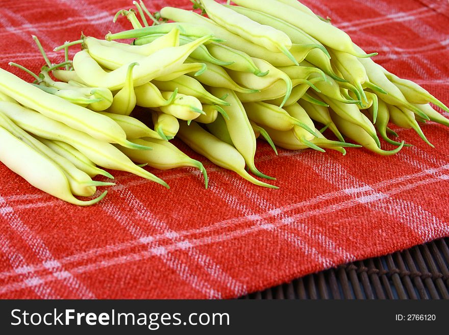 String yellow beans on a white background