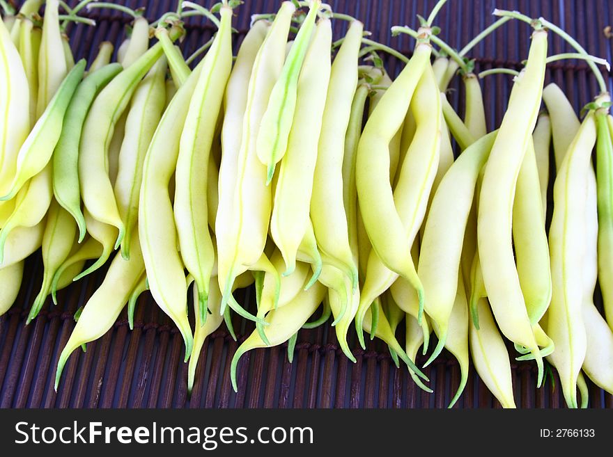 String yellow beans on a white background