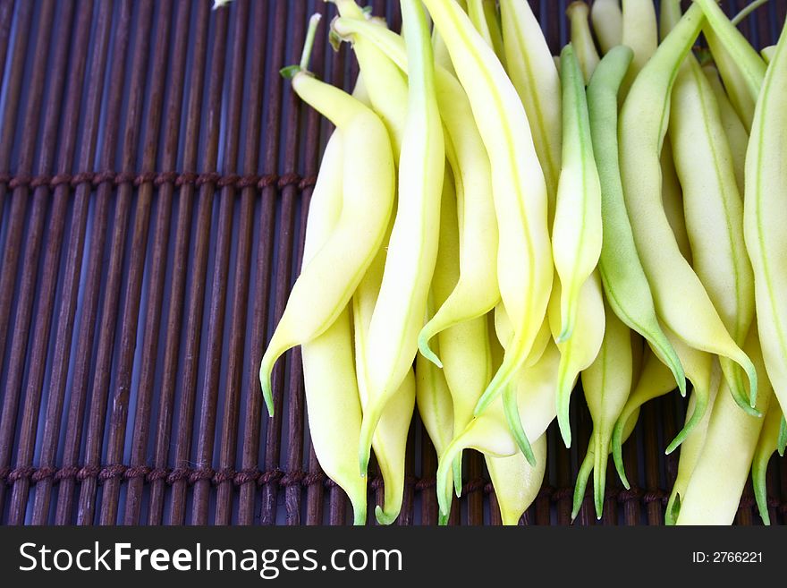 String yellow beans on a white background