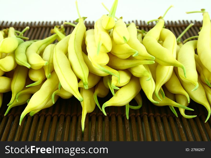 String yellow beans on a white background