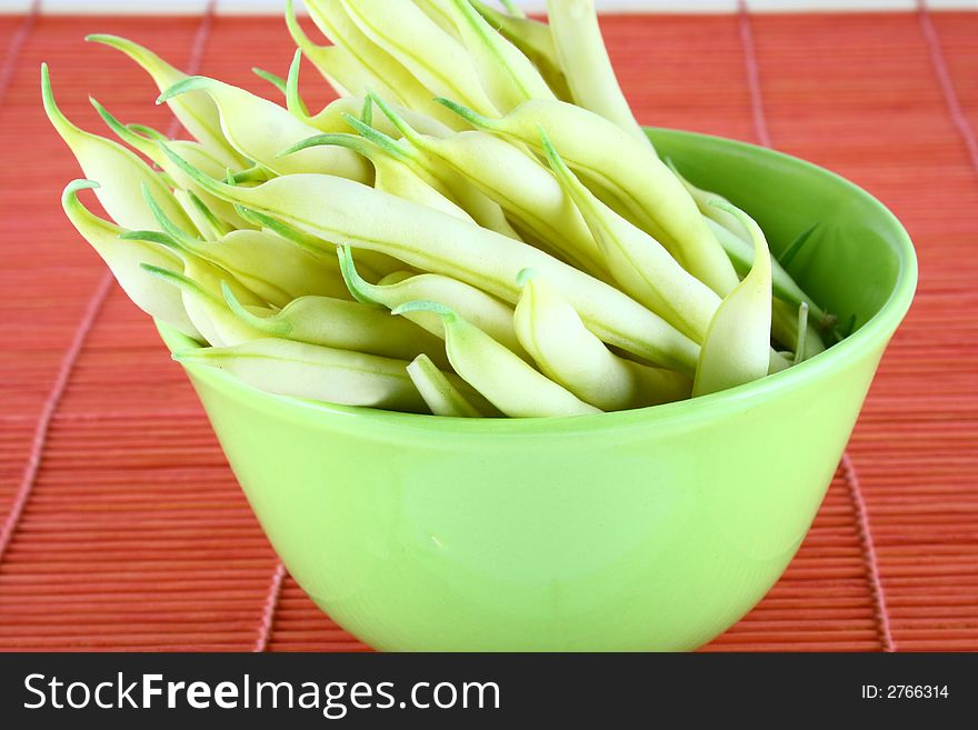 String yellow beans on a white background