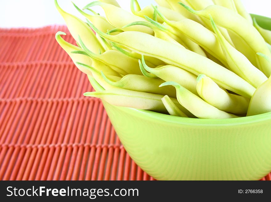 String yellow beans on a white background