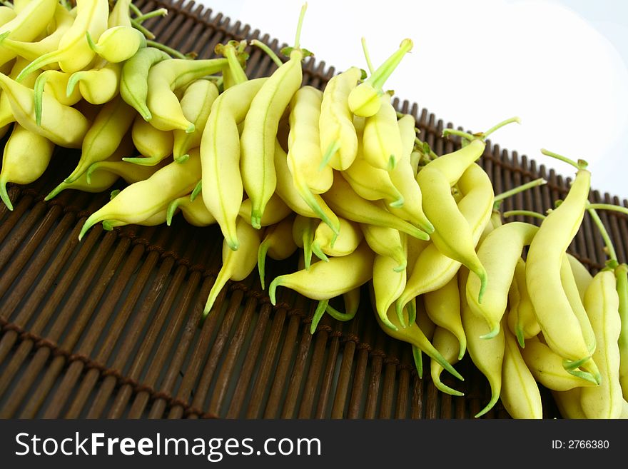 String yellow beans on a white background