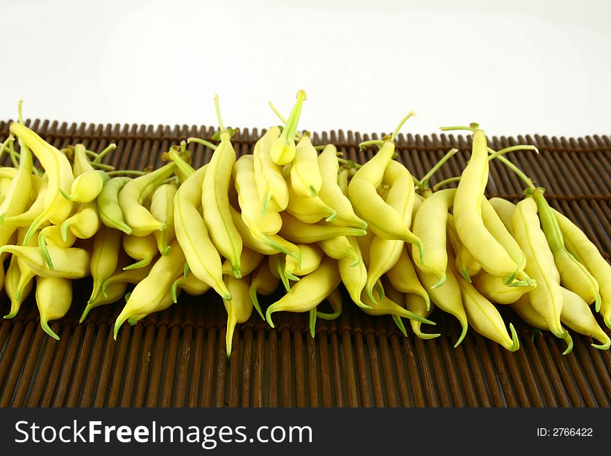 String yellow beans on a white background