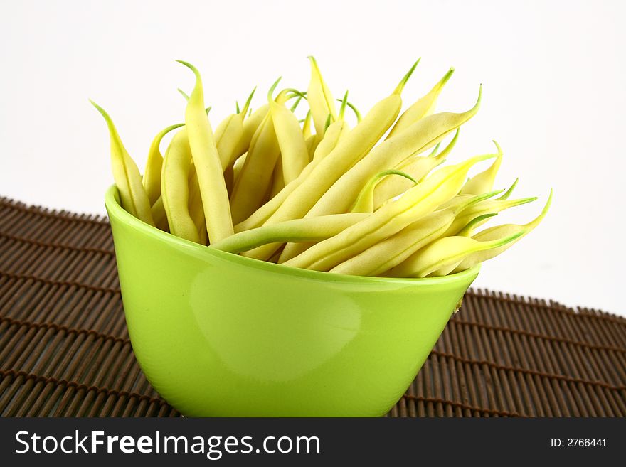 String yellow beans on a white background