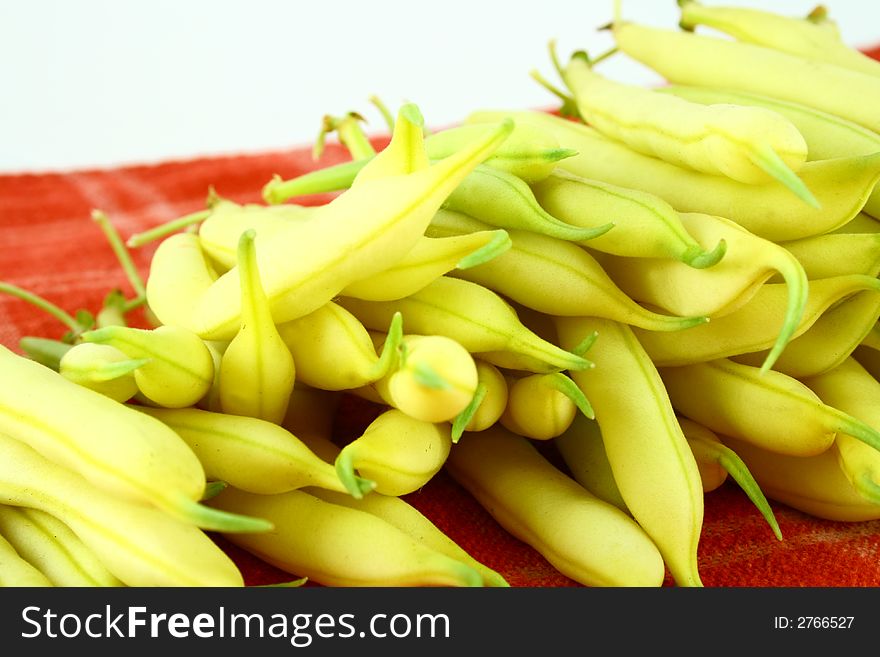 String yellow beans on a white background