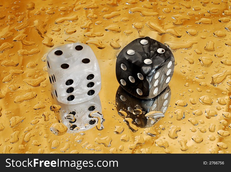 Dice on golden background with droplets showing a hard eight. Dice on golden background with droplets showing a hard eight