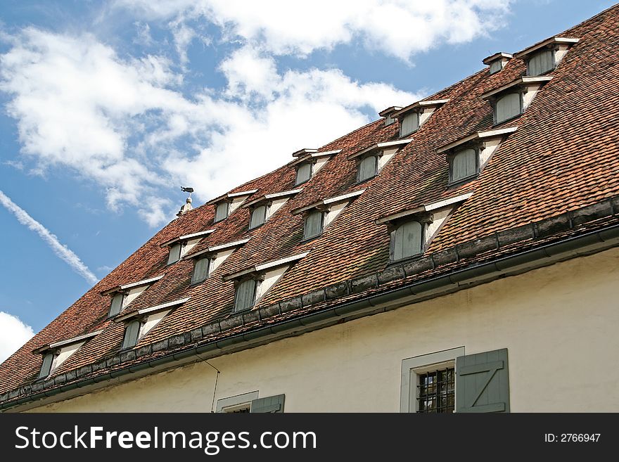 The tiled roof of an old building in Munich, Germany. The tiled roof of an old building in Munich, Germany
