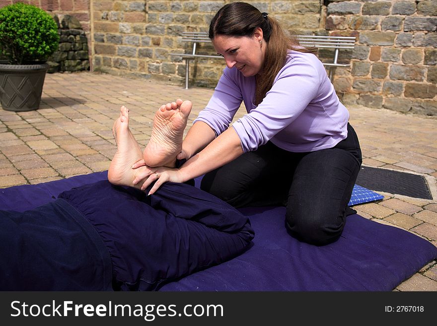 Stretching the quads as part of a Thai body massage