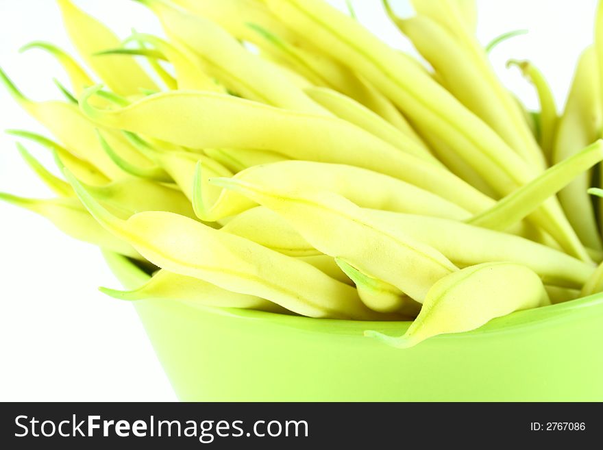 String yellow beans on a white background