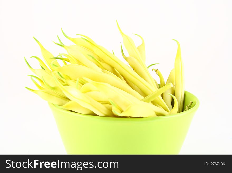 String yellow beans on a white background