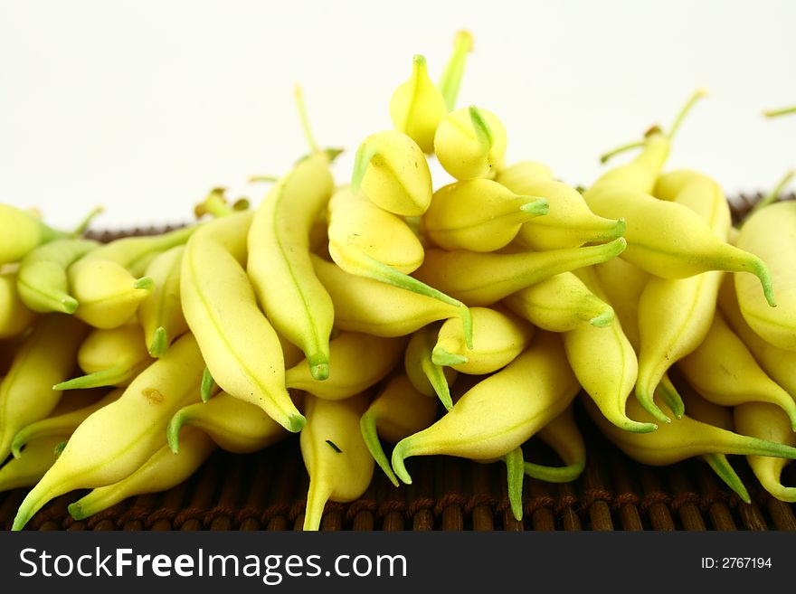 String yellow beans on a white background