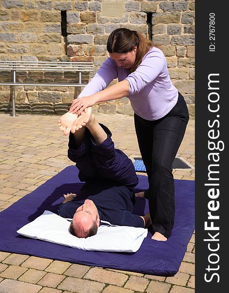 Leg and lower back stretch as part of a Thai massage