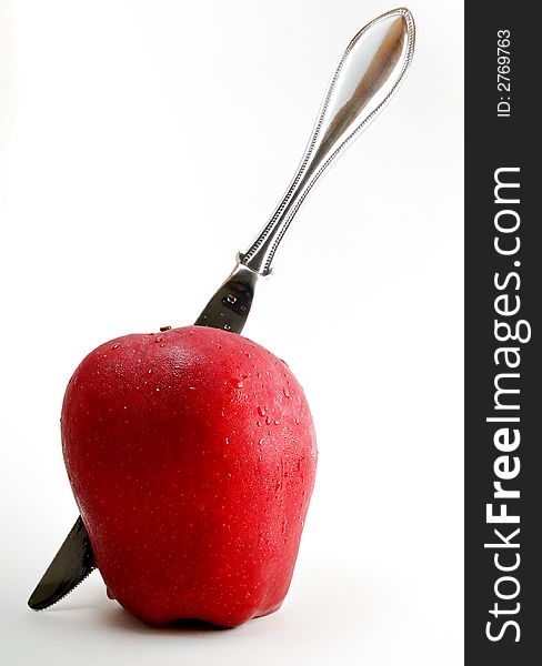 Sharp knife through a red apple. Sharp knife through a red apple