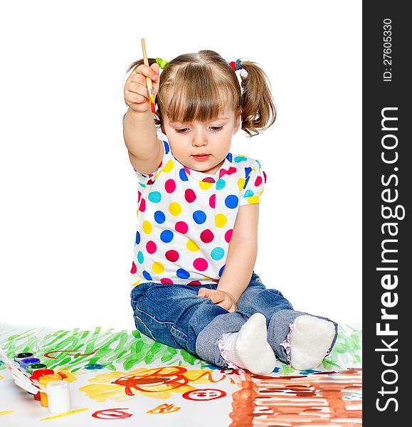 Portrait of a young girl which draws paint sitting on the floor. Portrait of a young girl which draws paint sitting on the floor