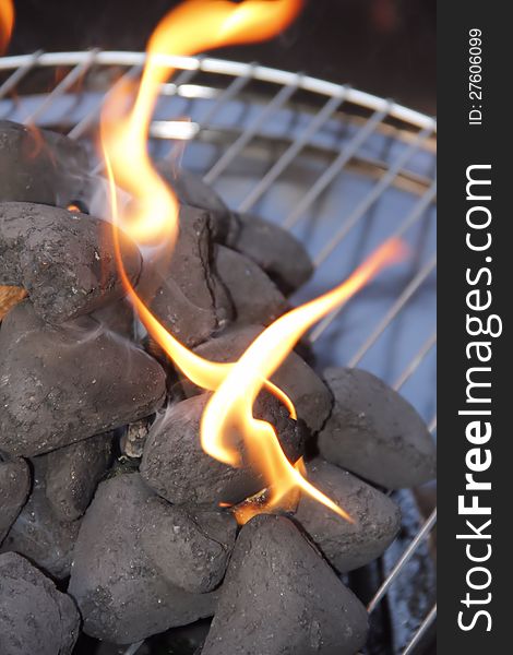 Black charcoal briquettes are burning for bbq. Black charcoal briquettes are burning for bbq