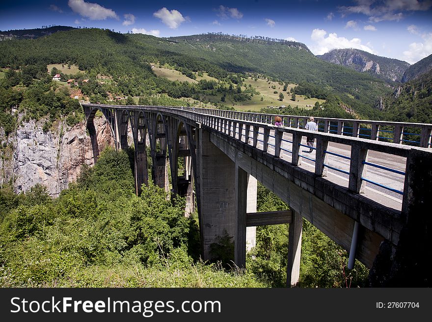 The Djurdjevica Tara bridge, connects two rocky sides of deep Tara's river canyon, Montenegro. The Djurdjevica Tara bridge, connects two rocky sides of deep Tara's river canyon, Montenegro.