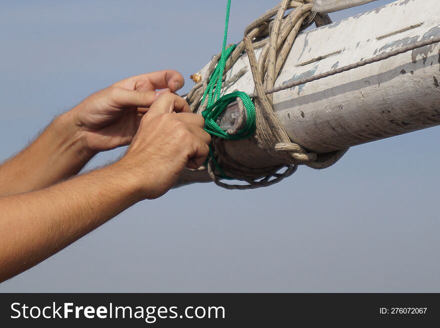 Hands with the green rope