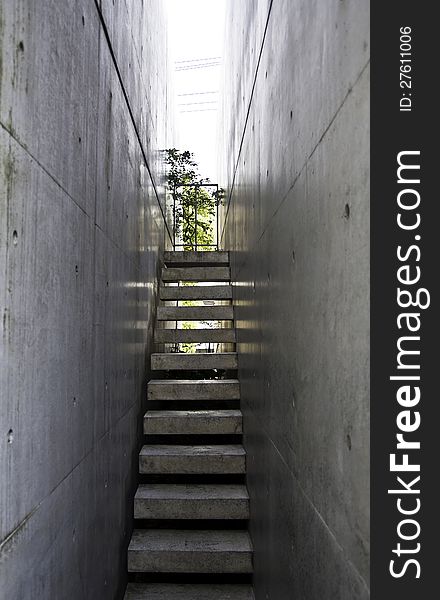 Modern Stairway to the light with bare concrete wall