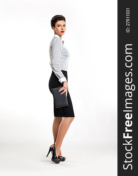 Full length portrait of confident young business woman secretary with handbag sideways. Full length portrait of confident young business woman secretary with handbag sideways