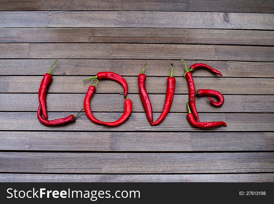 The word love on a brown table from hot red peppers of Chile