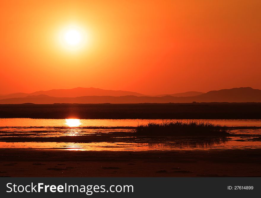 Sunset over marsh, beautiful landscape, golden river