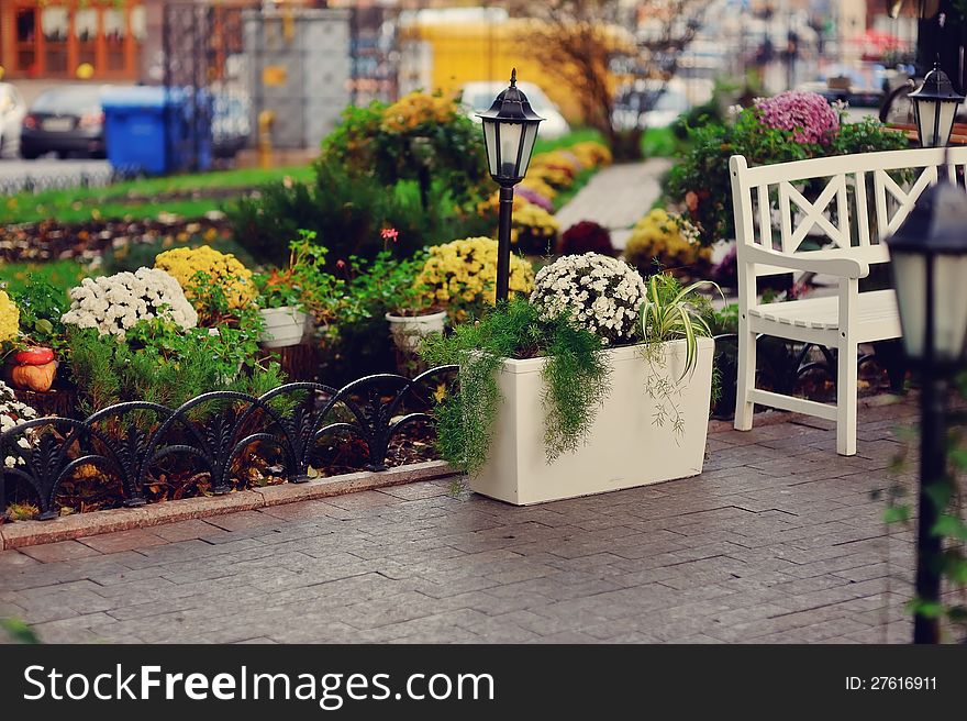 Autumn view of the yard with flower beds and with beautiful lanterns. Autumn view of the yard with flower beds and with beautiful lanterns