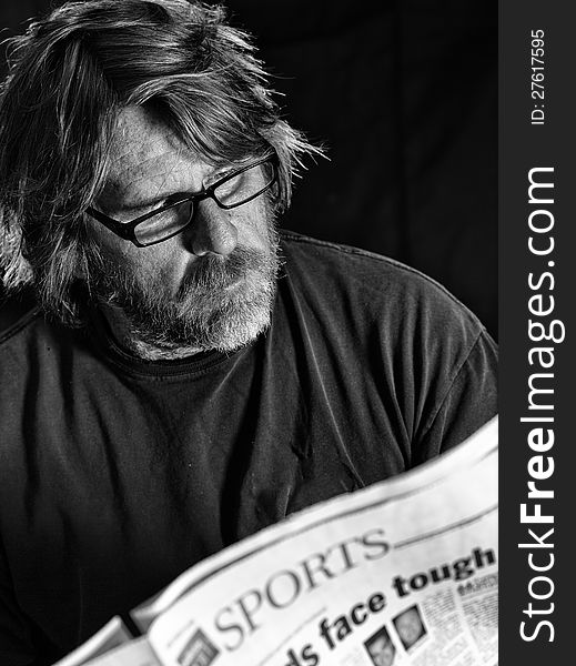 Man Reads Newspaper