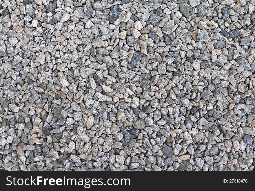 Textured background of pale crushed stone