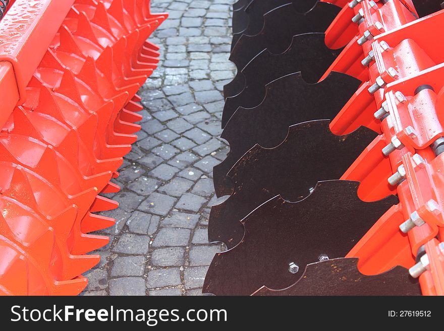 Details of agricultural equipment harness.Red and black giant farming plough