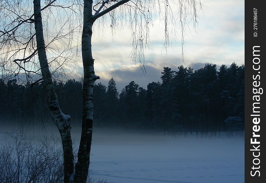 Beautiful view of a winter lake. A winter fog and lake create a dreamy scene.