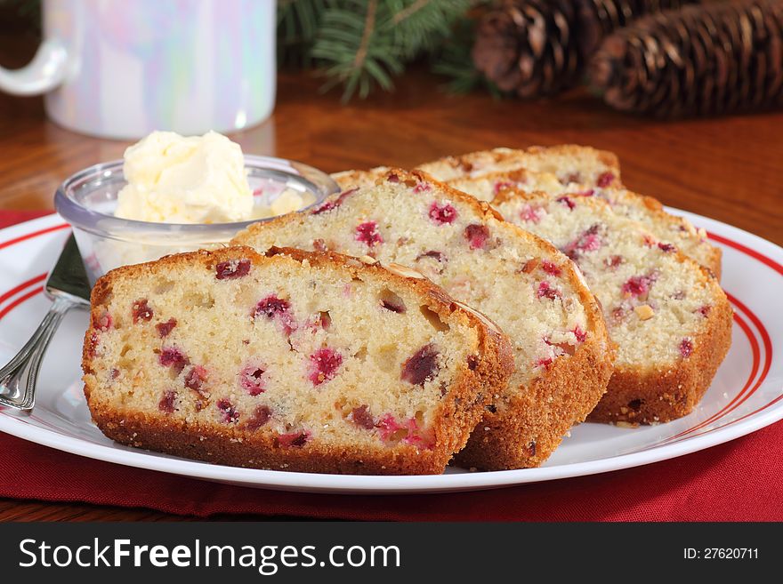 Slices of cranberry bread with butter on a plate. Slices of cranberry bread with butter on a plate