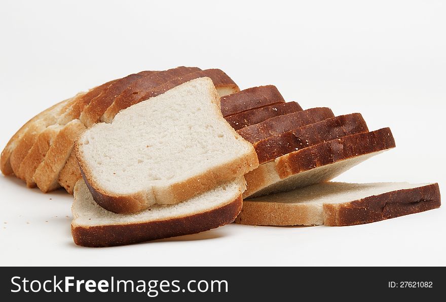 The cut loaf of white loaf for toasters on a white background. The cut loaf of white loaf for toasters on a white background